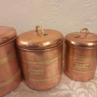 vintage set of four coppoer kitchen canisters with brass handles