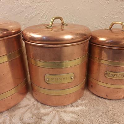 vintage set of four coppoer kitchen canisters with brass handles