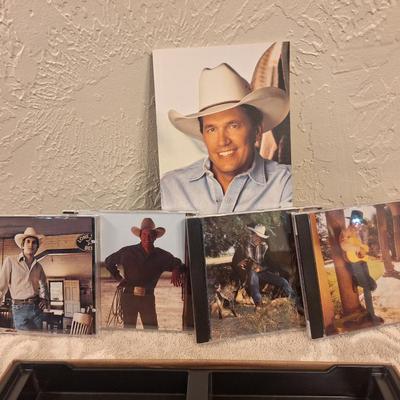 CD sets for Garth Brooks and George Straight.  5 CDs for Garth, 4 for George