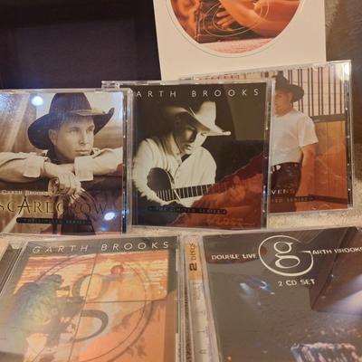 CD sets for Garth Brooks and George Straight.  5 CDs for Garth, 4 for George