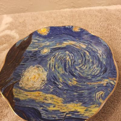 two porcelain teacups and saucers featuring prints of Vincent van Gogh paintings.   The Sower and The Starry Night
