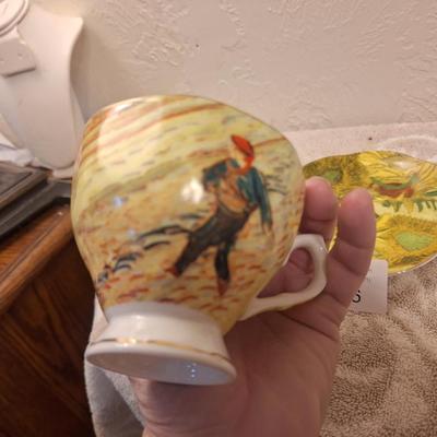 two porcelain teacups and saucers featuring prints of Vincent van Gogh paintings.   The Sower and The Starry Night