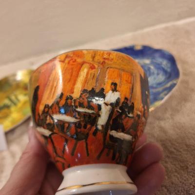 two porcelain teacups and saucers featuring prints of Vincent van Gogh paintings.   The Sower and The Starry Night