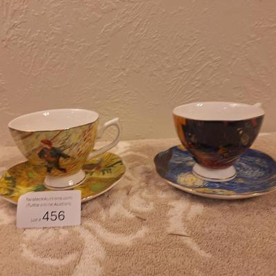 two porcelain teacups and saucers featuring prints of Vincent van Gogh paintings.   The Sower and The Starry Night