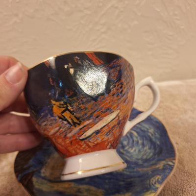 two porcelain teacups and saucers featuring prints of Vincent van Gogh paintings.   The Sower and The Starry Night