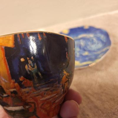 two porcelain teacups and saucers featuring prints of Vincent van Gogh paintings.   The Sower and The Starry Night