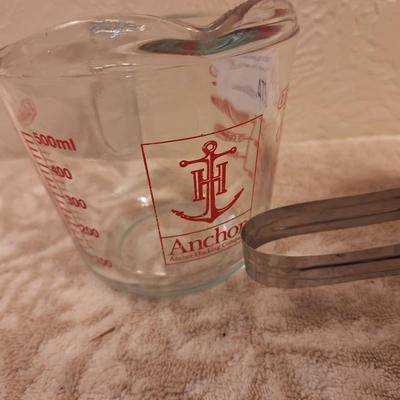 Anchor Hocking 2-cup (16-ounce) glass measuring cup and a metal flour sifter.