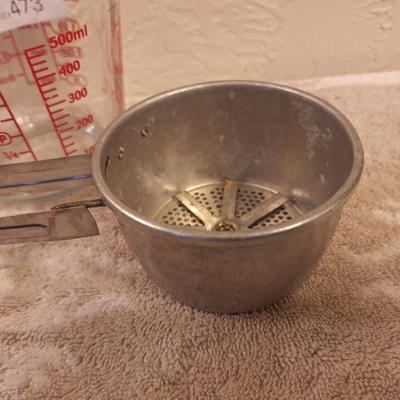 Anchor Hocking 2-cup (16-ounce) glass measuring cup and a metal flour sifter.