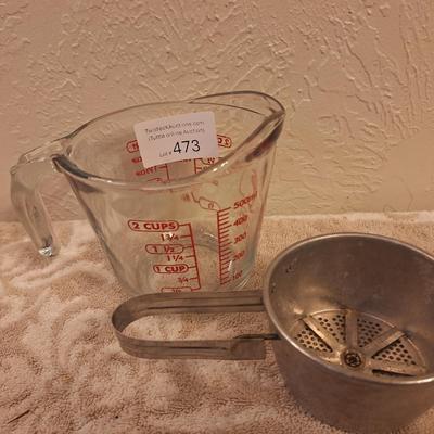 Anchor Hocking 2-cup (16-ounce) glass measuring cup and a metal flour sifter.