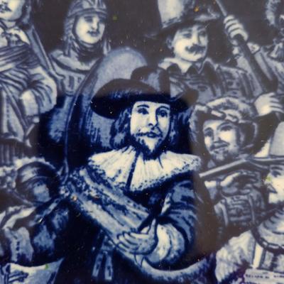 Sale Photo Thumbnail #161: This lot is for a Rembrandt on Delft Blue Tile. This tile displays a reproduction of Rembrandt van Rijn's famous painting, The Night Watch.  Nicley framed from the 1950s.  The original painting is in Amsterdam but you can have this nifty reproduction if y