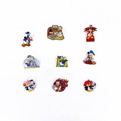 Sale Photo Thumbnail #371: set of 9 Pins. Donald Duck collector Pin in good used condition. Featuring Adventureland, Halloween Pumpkin, D for Donald, Baker Donald, etc