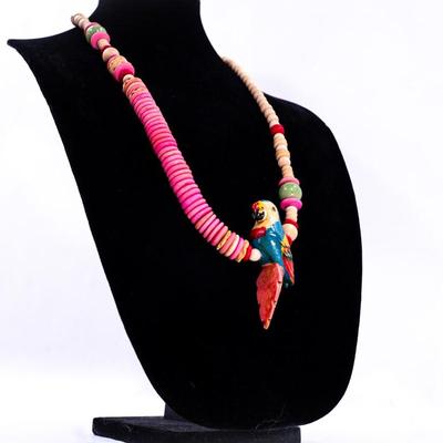 Sale Photo Thumbnail #416: This is a vintage hand- carved wood parrot beaded necklace.