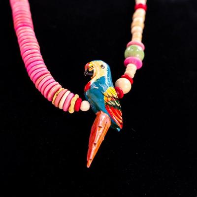 Sale Photo Thumbnail #418: This is a vintage hand- carved wood parrot beaded necklace.