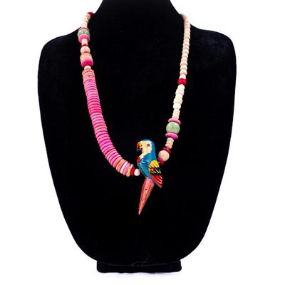 Sale Photo Thumbnail #415: This is a vintage hand- carved wood parrot beaded necklace.