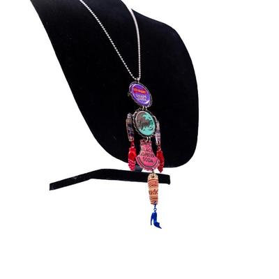 Sale Photo Thumbnail #427: This is an upcycled, industrial- inspired bottle cap necklace featuring various soda bottle caps, including "Old Colony Grape Soda,' "Lymette," and "Black".