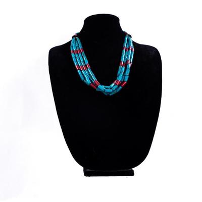 Sale Photo Thumbnail #429: This is a multi-strand Native American turquoise and coral beads necklace, possibly featuring a jacla pendant and silver accents.