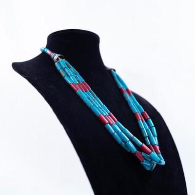 Sale Photo Thumbnail #433: This is a multi-strand Native American turquoise and coral beads necklace, possibly featuring a jacla pendant and silver accents.