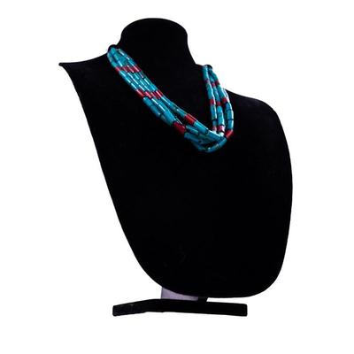 Sale Photo Thumbnail #432: This is a multi-strand Native American turquoise and coral beads necklace, possibly featuring a jacla pendant and silver accents.