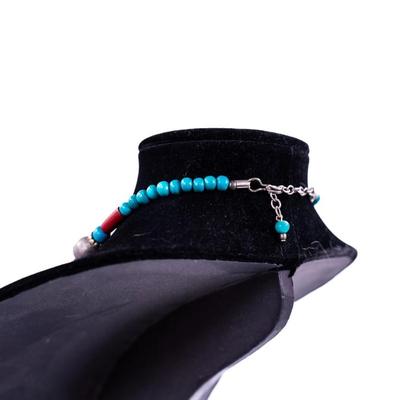 Sale Photo Thumbnail #430: This is a multi-strand Native American turquoise and coral beads necklace, possibly featuring a jacla pendant and silver accents.