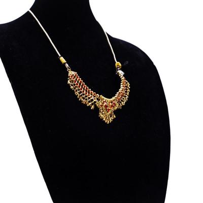 Sale Photo Thumbnail #437: This is a multicolor stone-studded traditional Indian necklace, possibly a kundan or jadau style, with matching turquoise and red bead necklace visible in the background.