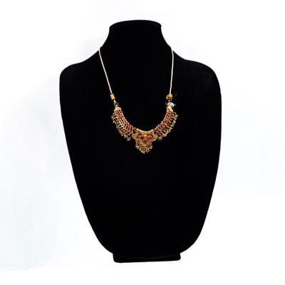 Sale Photo Thumbnail #438: This is a multicolor stone-studded traditional Indian necklace, possibly a kundan or jadau style, with matching turquoise and red bead necklace visible in the background.