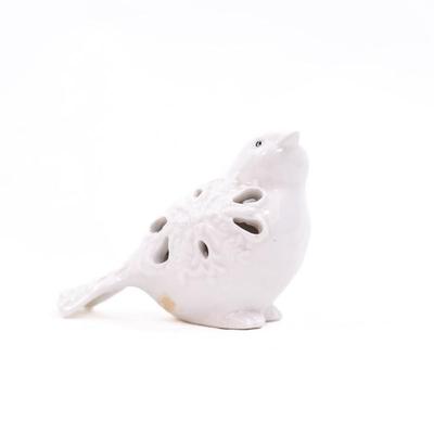 Sale Photo Thumbnail #444: This is a ceramic bird figurine with decorative cutouts. The figurine features a glossy finish and intricate cutouts on its body.