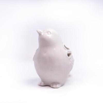 Sale Photo Thumbnail #443: This is a ceramic bird figurine with decorative cutouts. The figurine features a glossy finish and intricate cutouts on its body.