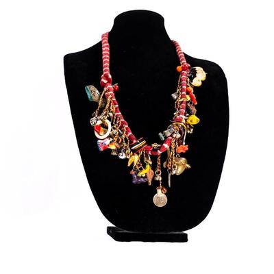 Sale Photo Thumbnail #454: This is a handcrafted charm neckace featuring a hand-dyed scarf base approximately 56 milagros and charchkas from around the world.