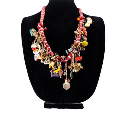 Sale Photo Thumbnail #453: This is a handcrafted charm neckace featuring a hand-dyed scarf base approximately 56 milagros and charchkas from around the world.