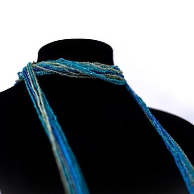 Sale Photo Thumbnail #460: This is a multistrand seed bead necklace in shades of blue, green, and white.