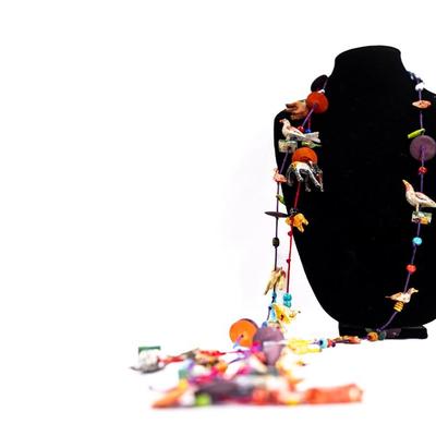 Sale Photo Thumbnail #464: This is a unique, handmade folk art necklace featuring carved and painted animals and disk beads. 1 animal has damage.