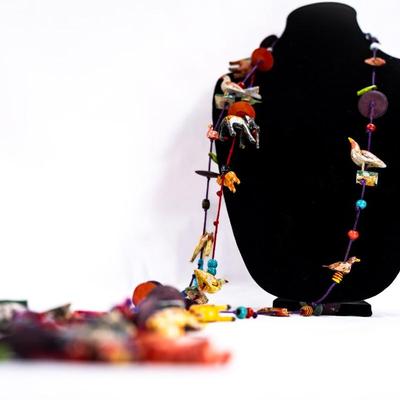 Sale Photo Thumbnail #465: This is a unique, handmade folk art necklace featuring carved and painted animals and disk beads. 1 animal has damage.