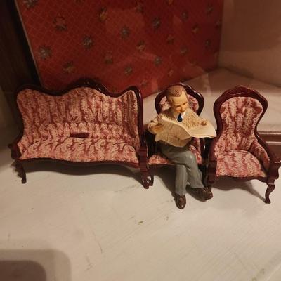 Man Reading Newspaper w/ Red Furniture