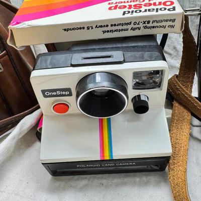 Sale Photo Thumbnail #378: All untested  1 Land camera with case, 2 One step Polaroids, one with brown leather case. 2 Instamatic Kodaks one with some used film inside. Extra gear flashes in an original box.   This is a Tokina RMC 80-200mm f/4 telephoto zoom lens. It is a manual fo