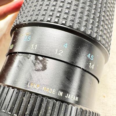 Sale Photo Thumbnail #395: All untested  1 Land camera with case, 2 One step Polaroids, one with brown leather case. 2 Instamatic Kodaks one with some used film inside. Extra gear flashes in an original box.   This is a Tokina RMC 80-200mm f/4 telephoto zoom lens. It is a manual fo