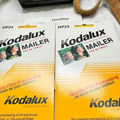 Sale Photo Thumbnail #382: All untested  1 Land camera with case, 2 One step Polaroids, one with brown leather case. 2 Instamatic Kodaks one with some used film inside. Extra gear flashes in an original box.   This is a Tokina RMC 80-200mm f/4 telephoto zoom lens. It is a manual fo