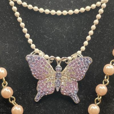 Pink cross and purple butterfly pendants