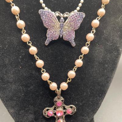 Pink cross and purple butterfly pendants