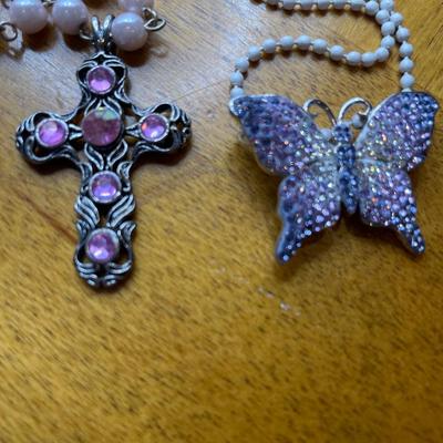 Pink cross and purple butterfly pendants