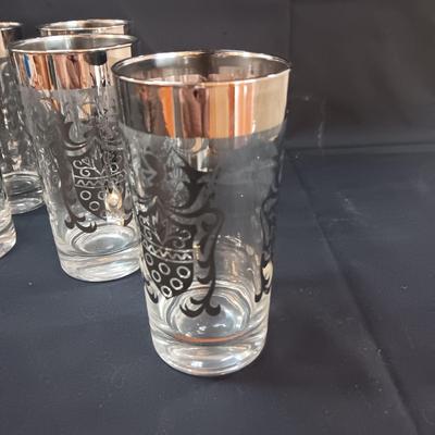 SEET OF MID-CENTURY KIMIKO SILVER KNIGHT SHIELD HIGHBALL GLASSES AND 4 METAL CANDLE HOLDERS