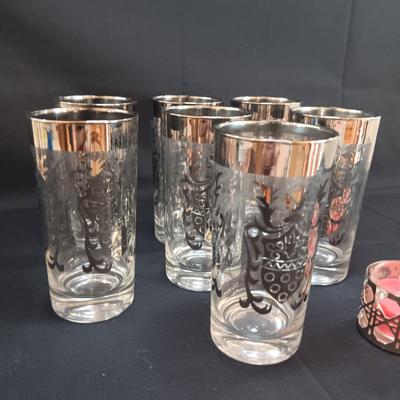 SEET OF MID-CENTURY KIMIKO SILVER KNIGHT SHIELD HIGHBALL GLASSES AND 4 METAL CANDLE HOLDERS