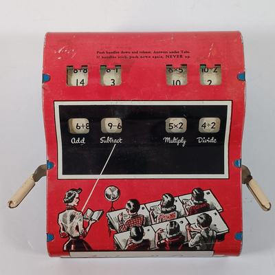 LOT 39: Vintage Wolverine Arithmetic Quiz Tin Toy