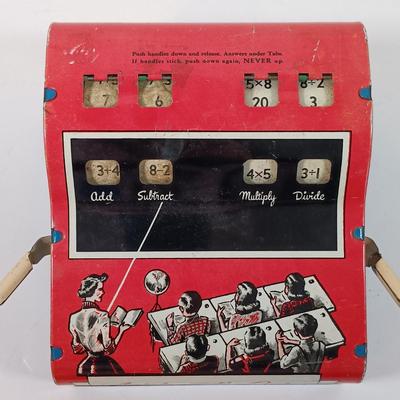 LOT 39: Vintage Wolverine Arithmetic Quiz Tin Toy