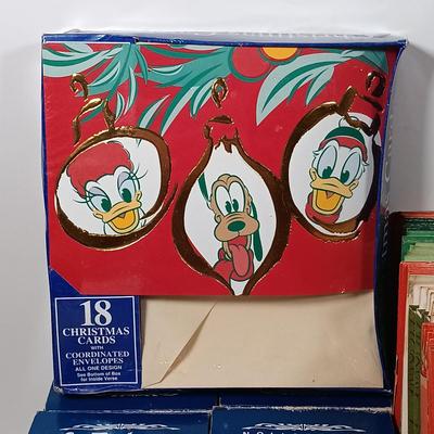 LOT 52: Vintage Munson Masterpiece Christmas Greeting Cards, Hallmark Mickey's Merry Carousel Ornament, A Dickens Christmas Cottages...