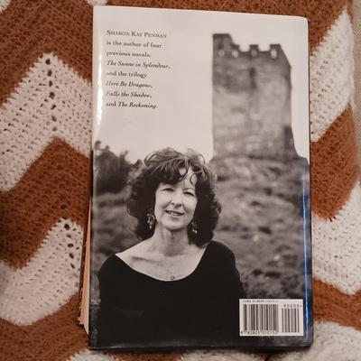 LOT 54: Collection of Stuart Wood and Sharon Kay Penman Hardback Novels with a Large Crocheted Throw Blanket