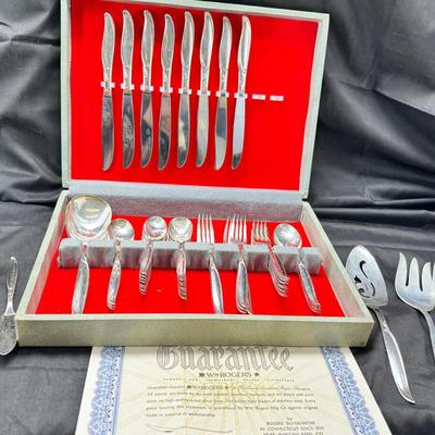 Sale Photo Thumbnail #459: Set for 12 ( 8 knives) with serving pieces in original tarnish proof box with COA. Lovely simple pattern Silver plate Service/6+  50's Mid-Century Modern ROGERS International Flatware SWEEP Pattern SWIRL in Handle w/Leaf Good Condition No Wear