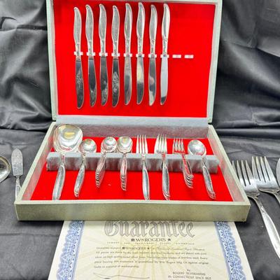 Sale Photo Thumbnail #466: Set for 12 ( 8 knives) with serving pieces in original tarnish proof box with COA. Lovely simple pattern Silver plate Service/6+  50's Mid-Century Modern ROGERS International Flatware SWEEP Pattern SWIRL in Handle w/Leaf Good Condition No Wear