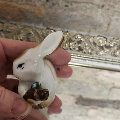 Sale Photo Thumbnail #138: Mirrored dresser tray with a pewter porringer, Hummel Girl with Geese, sleeping kitty, Bing and Grondahl thimble and a Zsolnay Bunny figurine