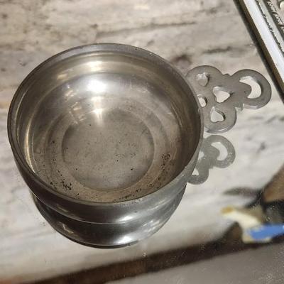 Sale Photo Thumbnail #142: Mirrored dresser tray with a pewter porringer, Hummel Girl with Geese, sleeping kitty, Bing and Grondahl thimble and a Zsolnay Bunny figurine
