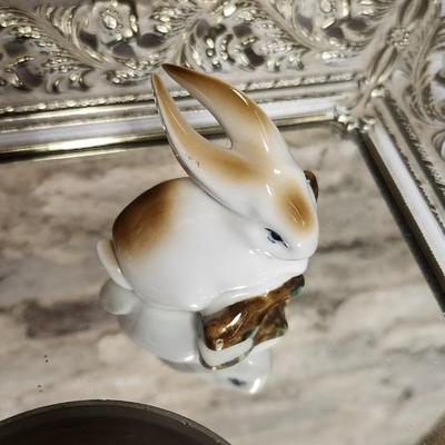 Sale Photo Thumbnail #136: Mirrored dresser tray with a pewter porringer, Hummel Girl with Geese, sleeping kitty, Bing and Grondahl thimble and a Zsolnay Bunny figurine